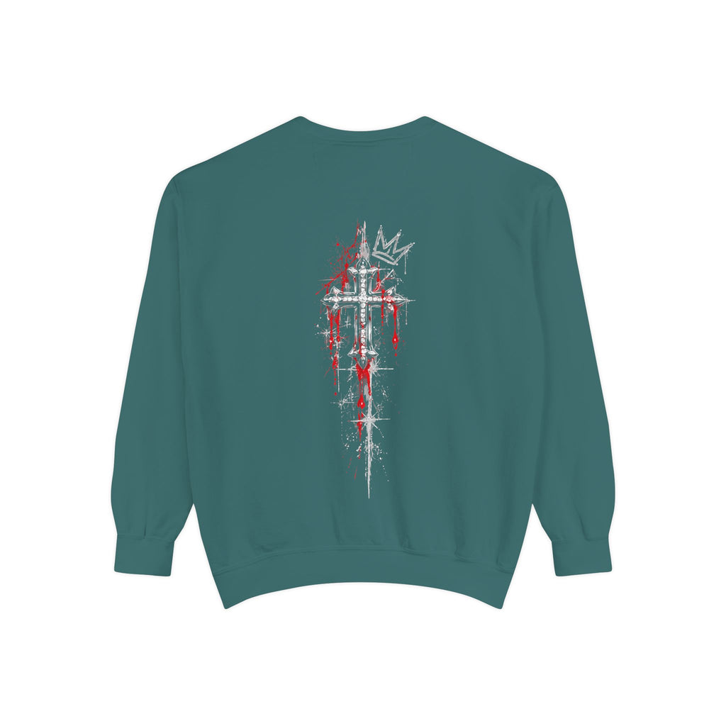 Teal sweatshirt back featuring a distressed white cross with red splatters and a crown graphic. Gothic streetwear design.